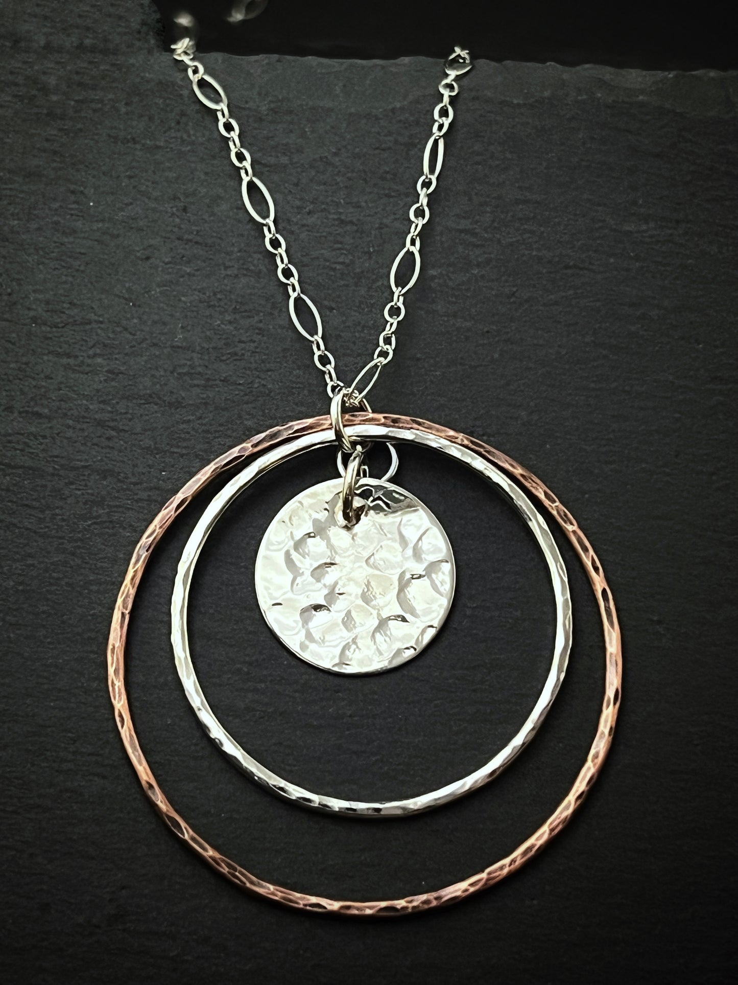 Sterling silver and copper forged hoop necklace with sterling silver disk