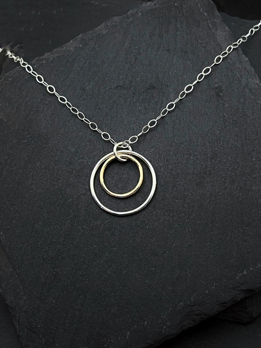 Forged sterling silver and 14 karat gold double hoop necklace