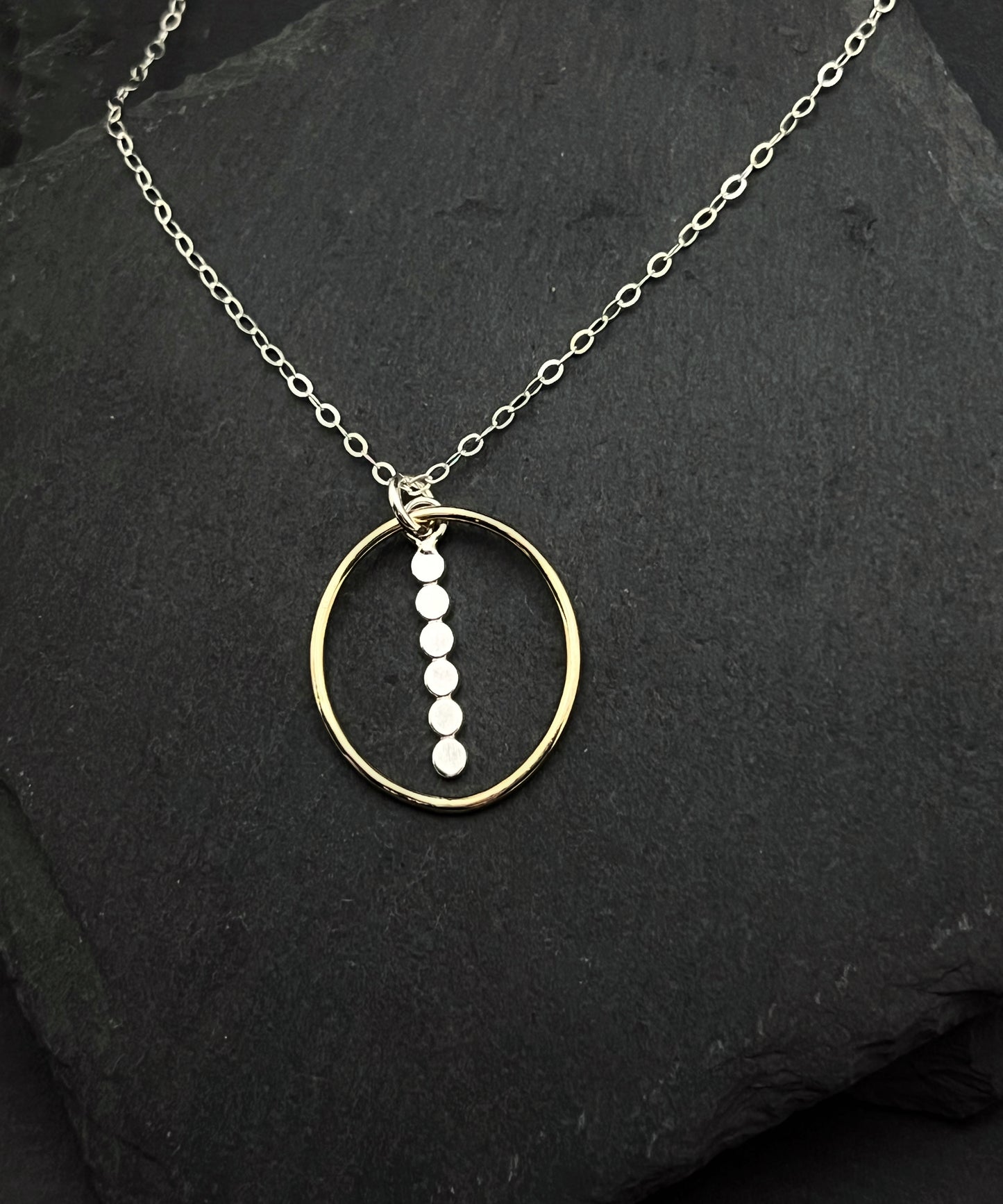 Forged sterling silver and 14 karat gold oval necklace