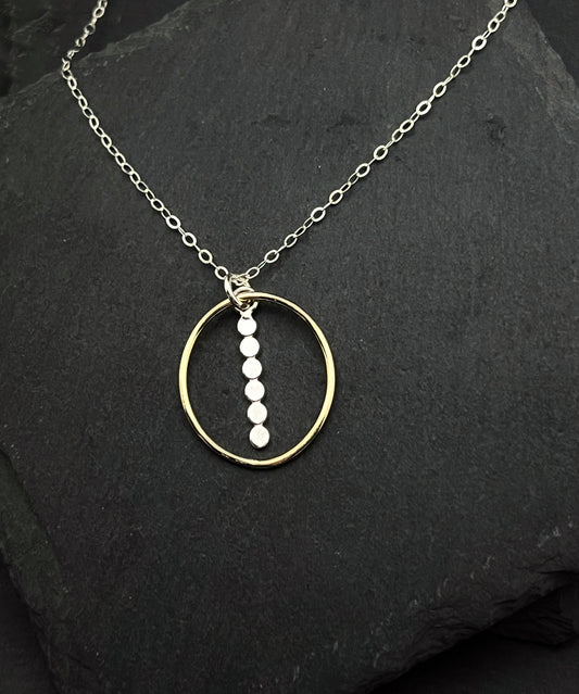 Forged sterling silver and 14 karat gold oval necklace