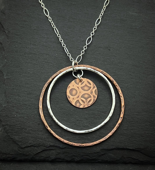 Sterling silver and copper forged hoop necklace with copper disk