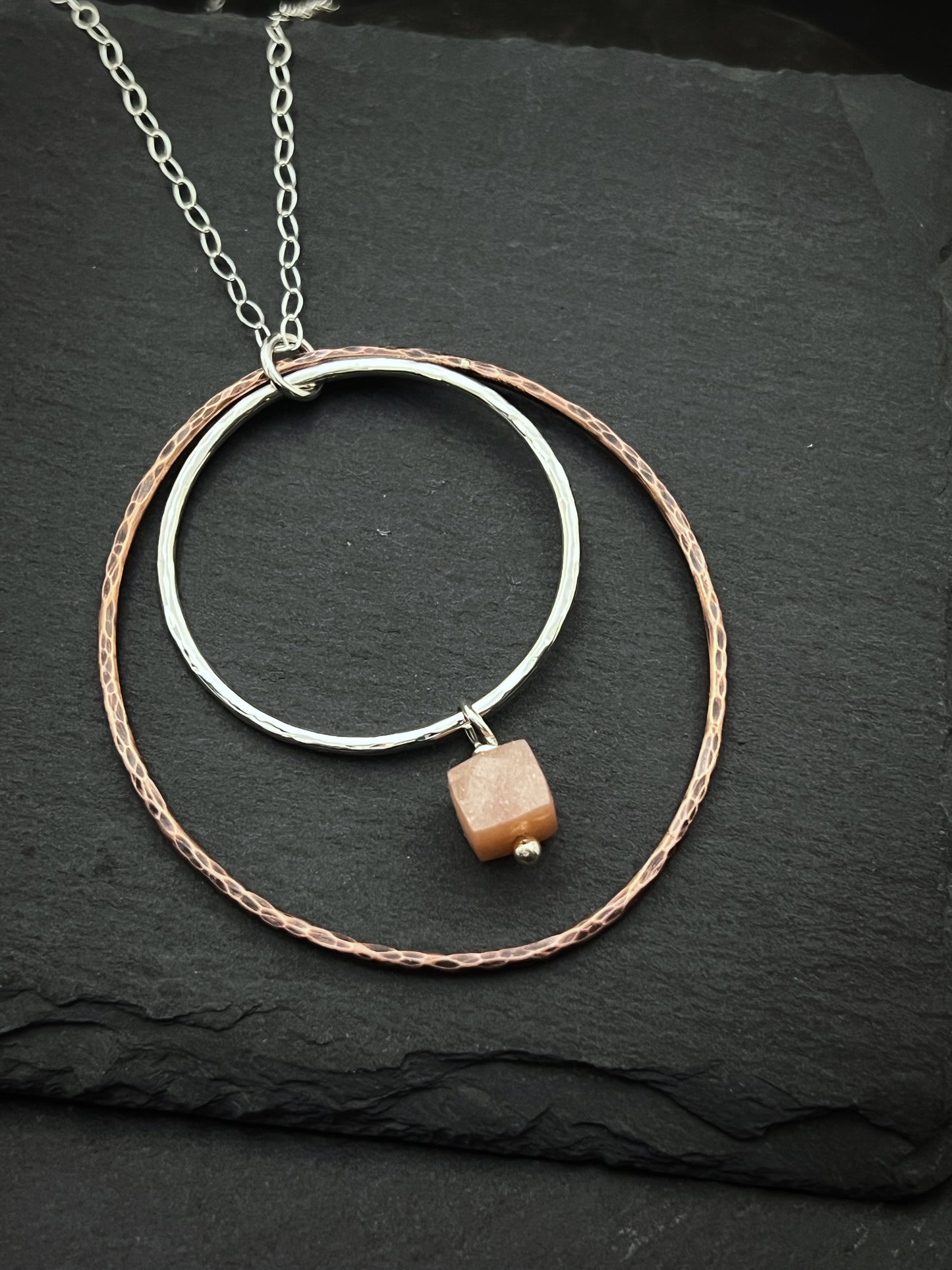 Sterling silver and copper forged hoop necklace with peach moonstone
