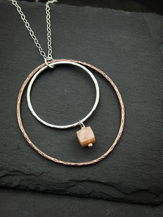 Sterling silver and copper forged hoop necklace with peach moonstone