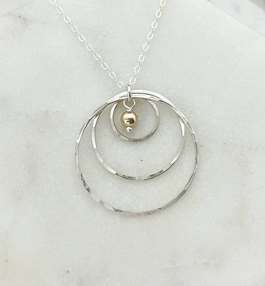 Mixed metals hoop necklace with 14 karat ball