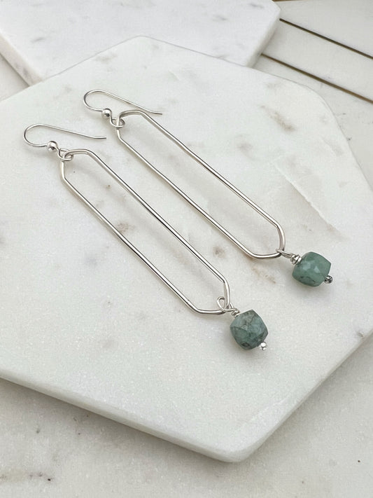 Sterling silver oval hoops with emerald