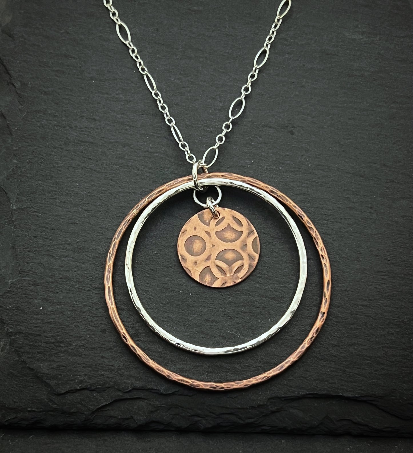 Sterling silver and copper forged hoop necklace with copper disk