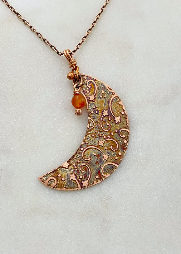 Crescent moon acid etched copper necklace with a carnelian gemstone