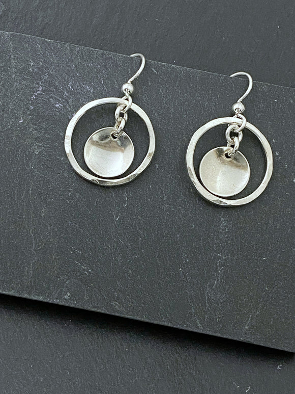 Sterling silver forged hoop earrings with sterling disk center