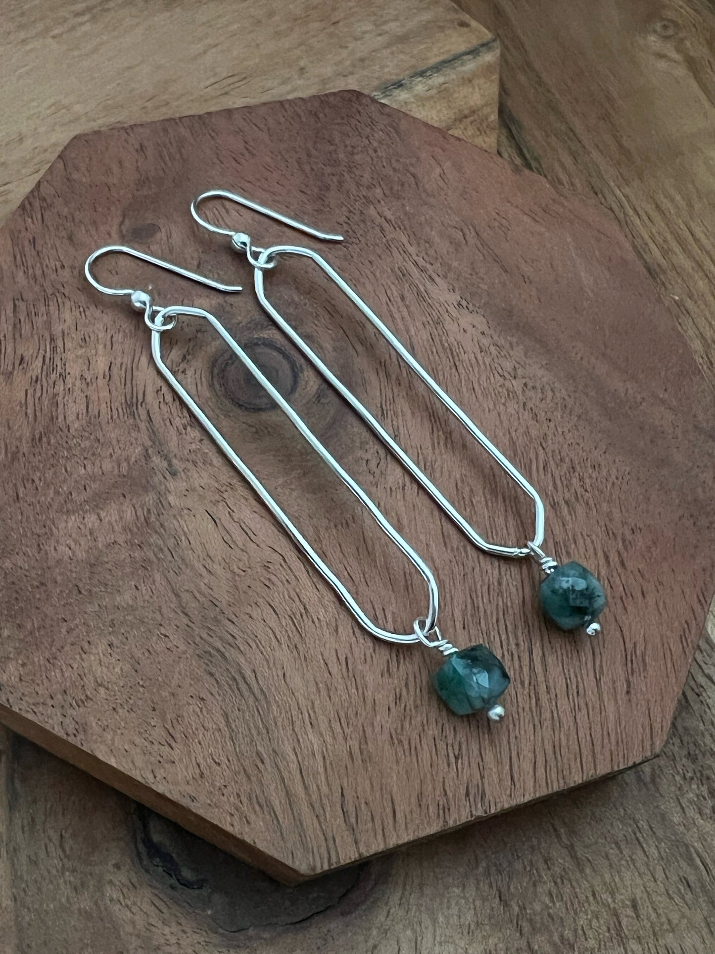 Sterling silver oval hoops with emerald