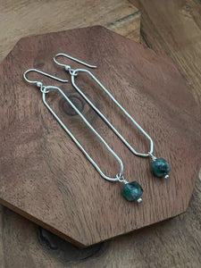 Sterling silver oval hoops with emerald