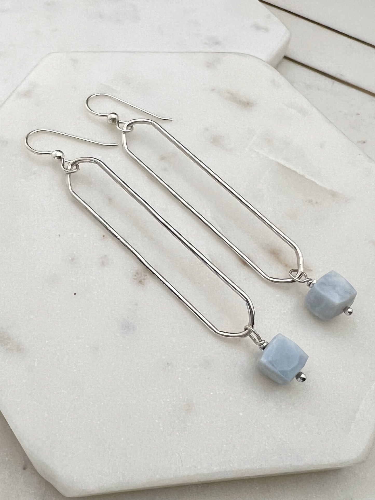 Sterling silver oval hoops with blue opal