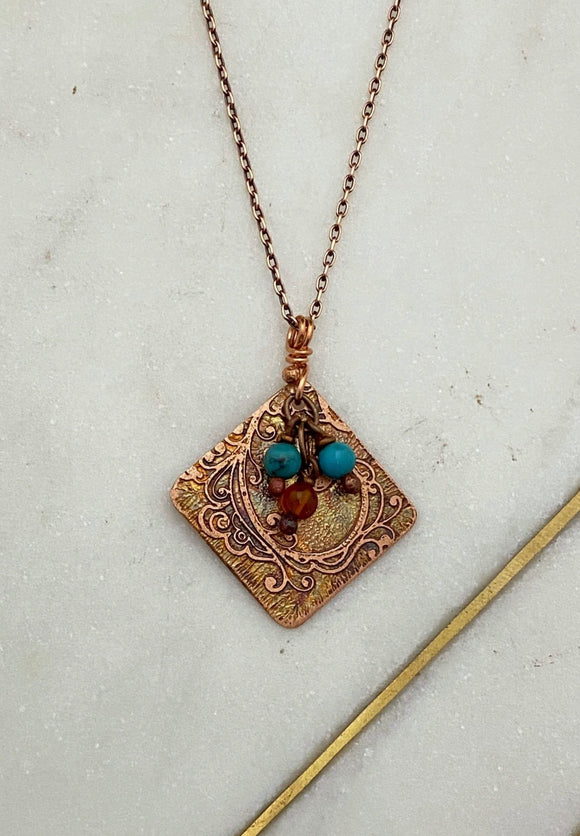 Acid etched copper swirl necklace with turquoise and carnelian