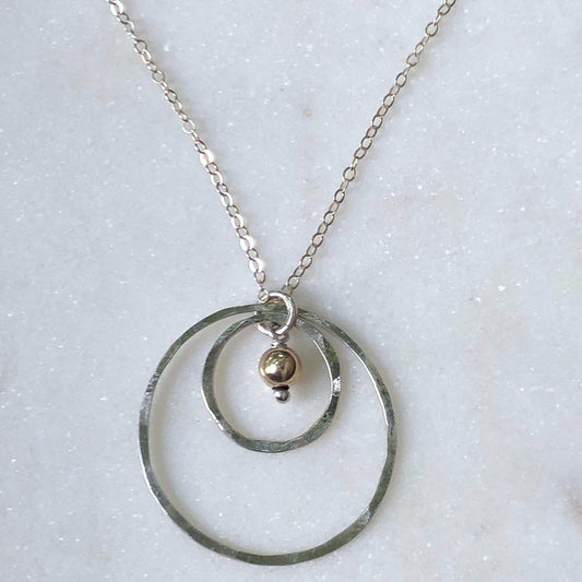 Sterling silver forged circle necklace with gold bead